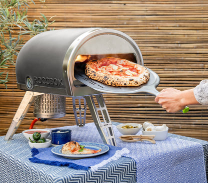 ROCCBOX Gozney Portable Outdoor Pizza Oven - Includes Professional Grade Pizza Peel, Built-In Thermometer and Safe Touch Silicone Jacket - Propane Gas Fired, With Rolling Wood Flame - Grey